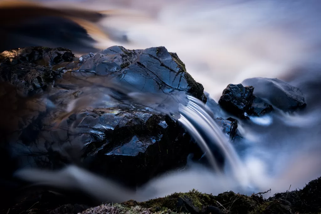 Slow shutter of water flowing over a rock