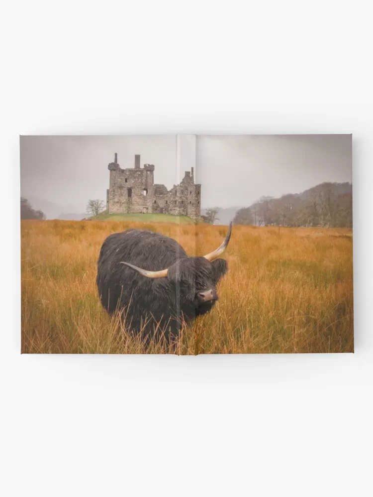 Kilchurn Castle being guarded by a highland cow! Hardcover Journal